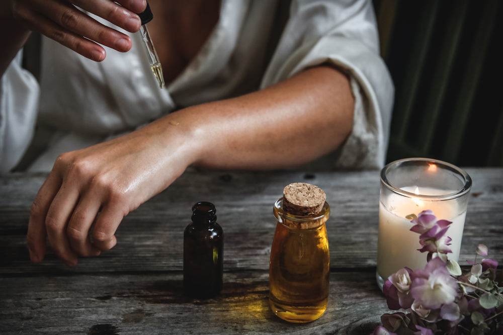 spiritual woman trying out her skincare gift bottles