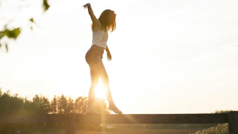 Woman practicing nervous system balance while walking outdoors