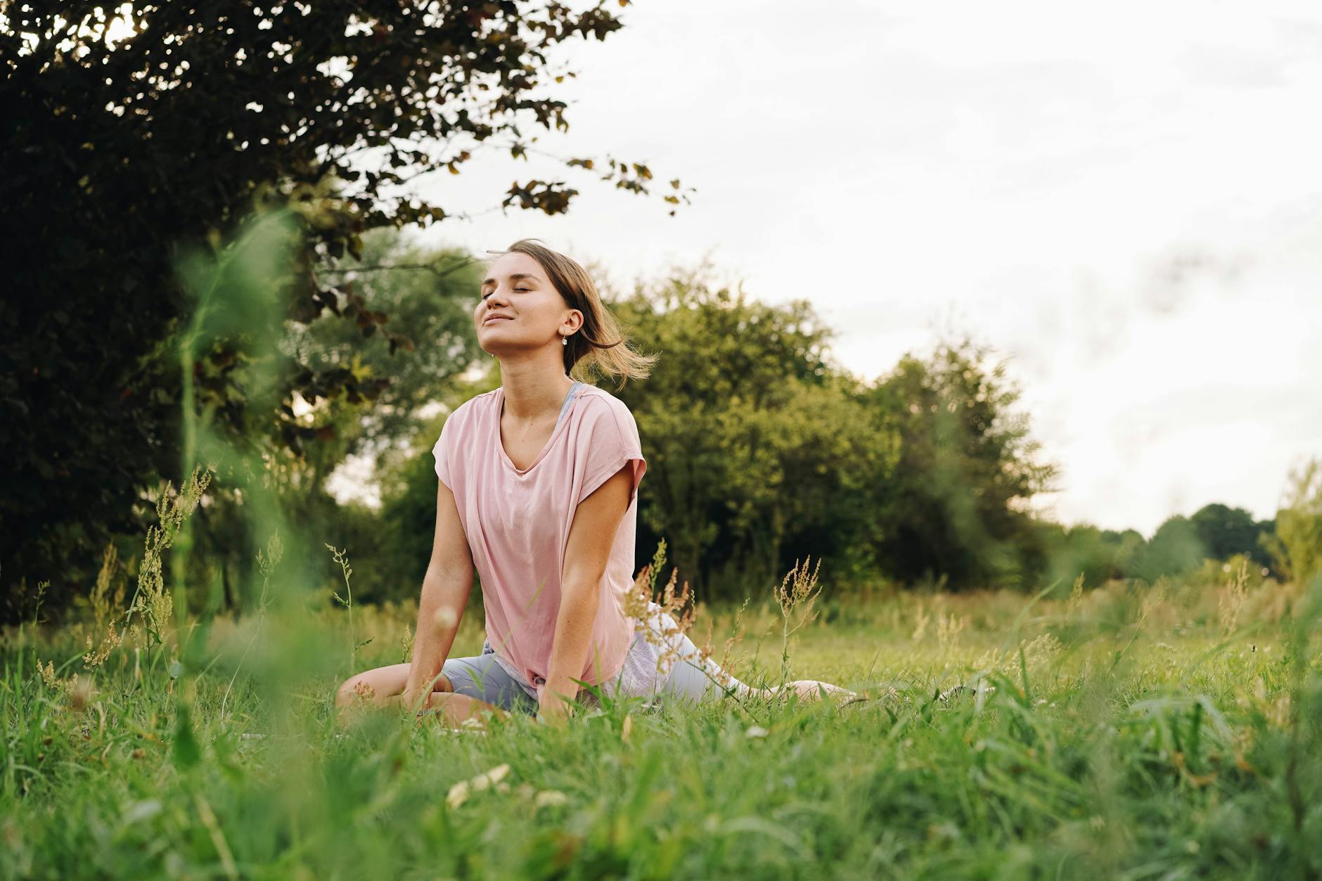 Woman practicing somatic therapy with gentle body awareness exercises