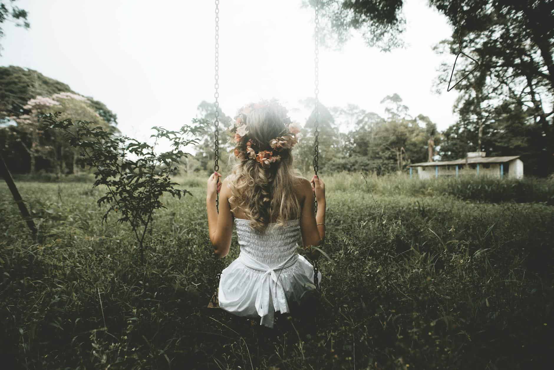 woman with wreath in hair on swing