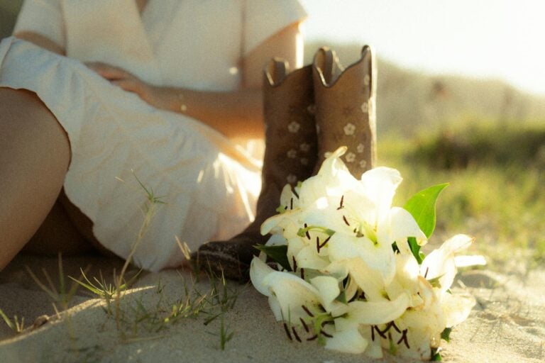 summer scene with cowboy boots and white lilies