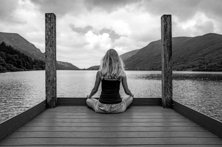 women sitting on dock mindfully