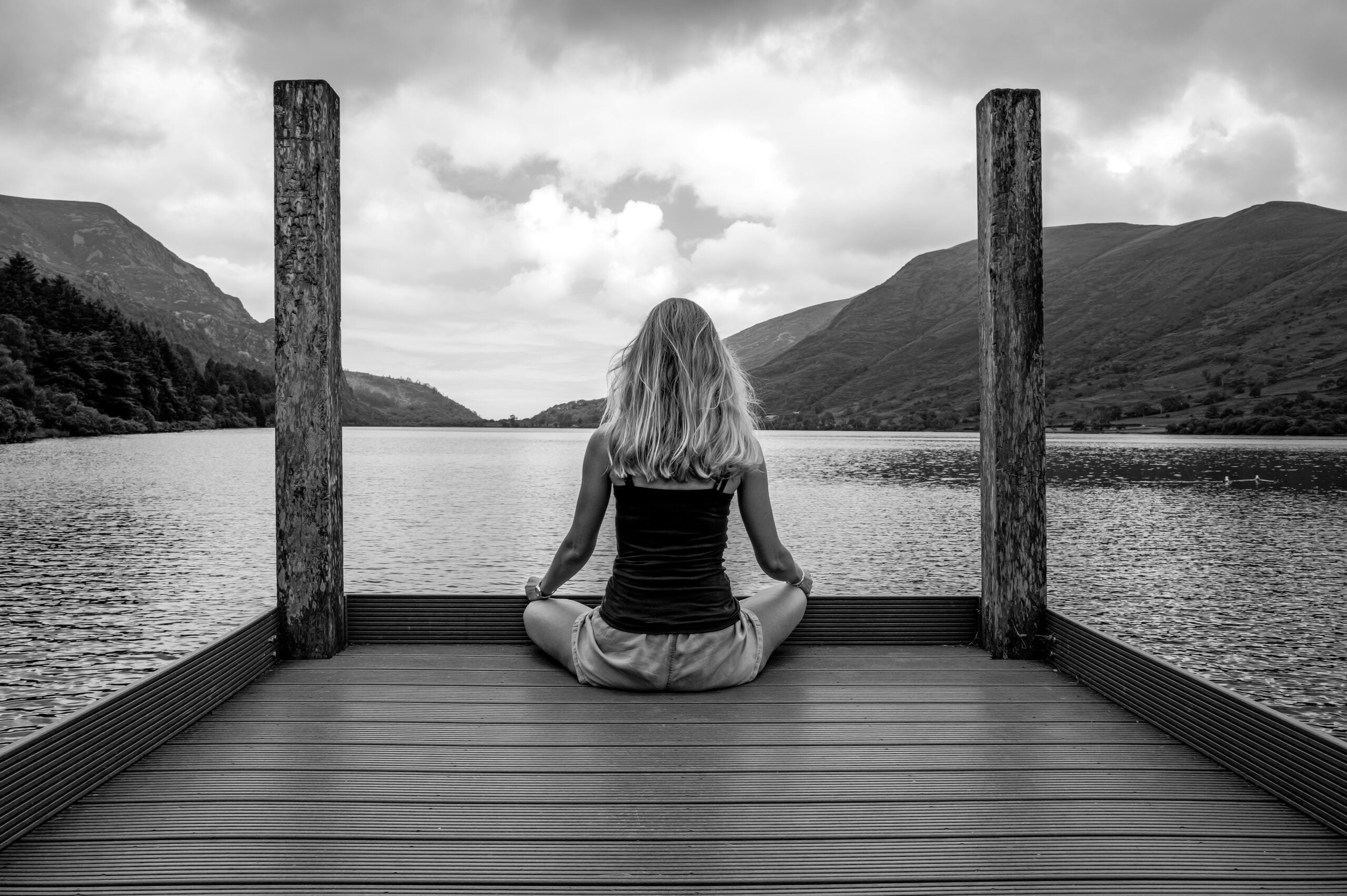 women sitting on dock mindfully