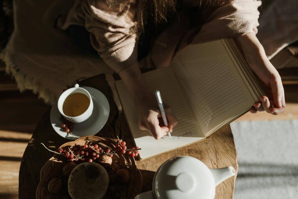a person writing on a notebook