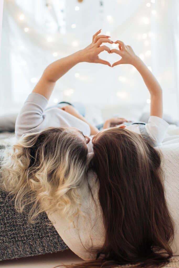 mother and daughter showing heart