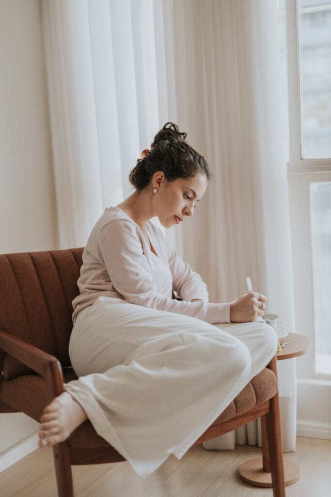 woman journaling in cozy indoor setting