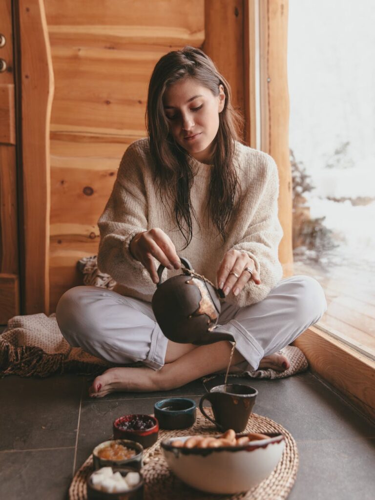 a woman making a cup of hot tea