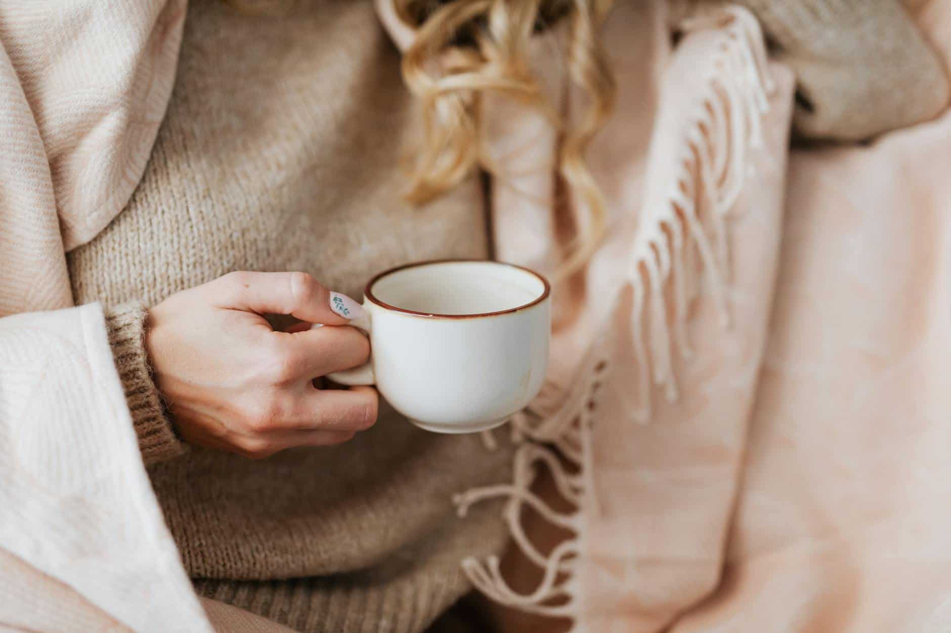close up of woman hand holding coffee cup