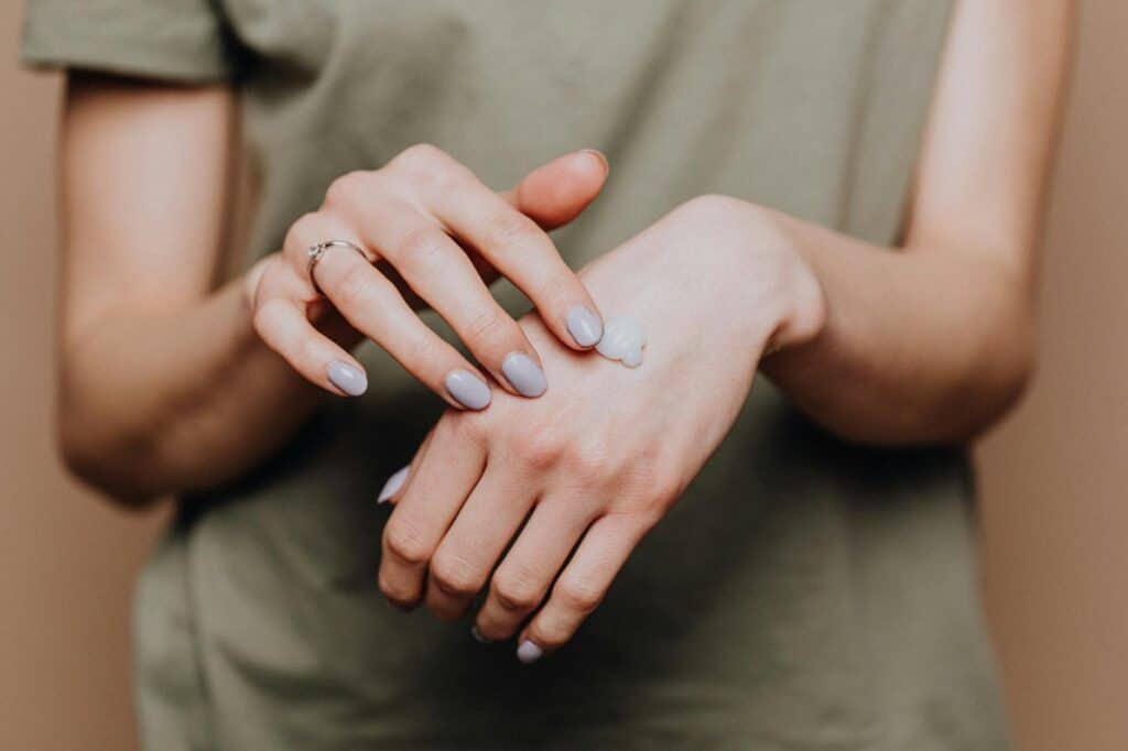 Woman practicing body mapping by tuning into physical sensations in her hands