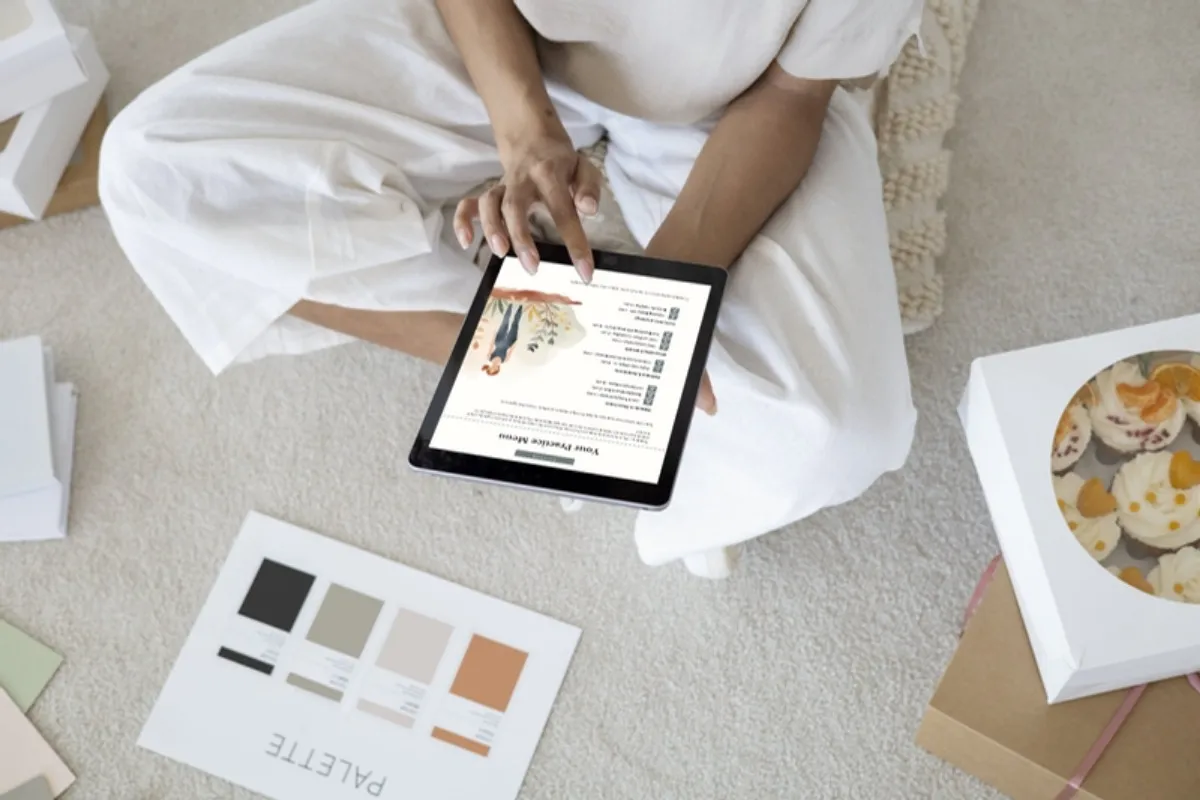 Woman cross legged with journal habit tracker ideas and color swatches