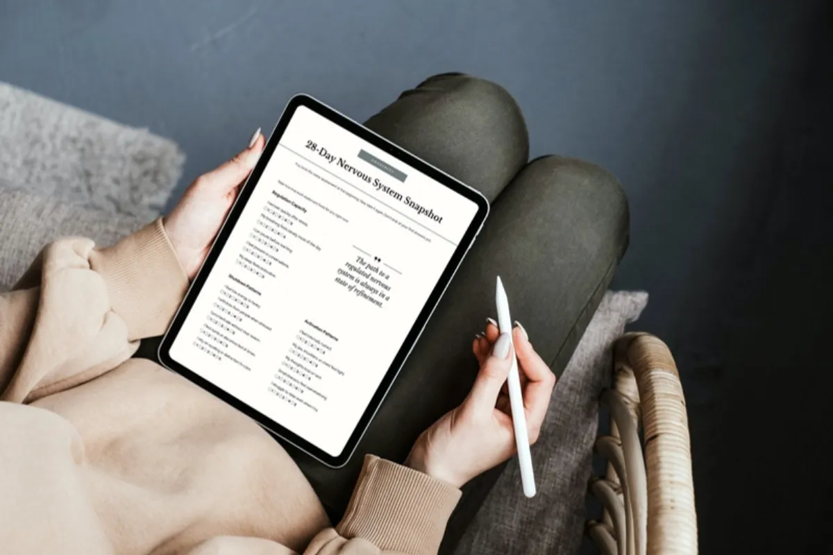 Woman using a nervous system habit tracker on cozy couch