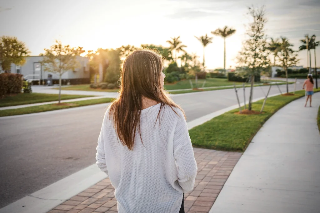woman walking in evening light to help with burnout
