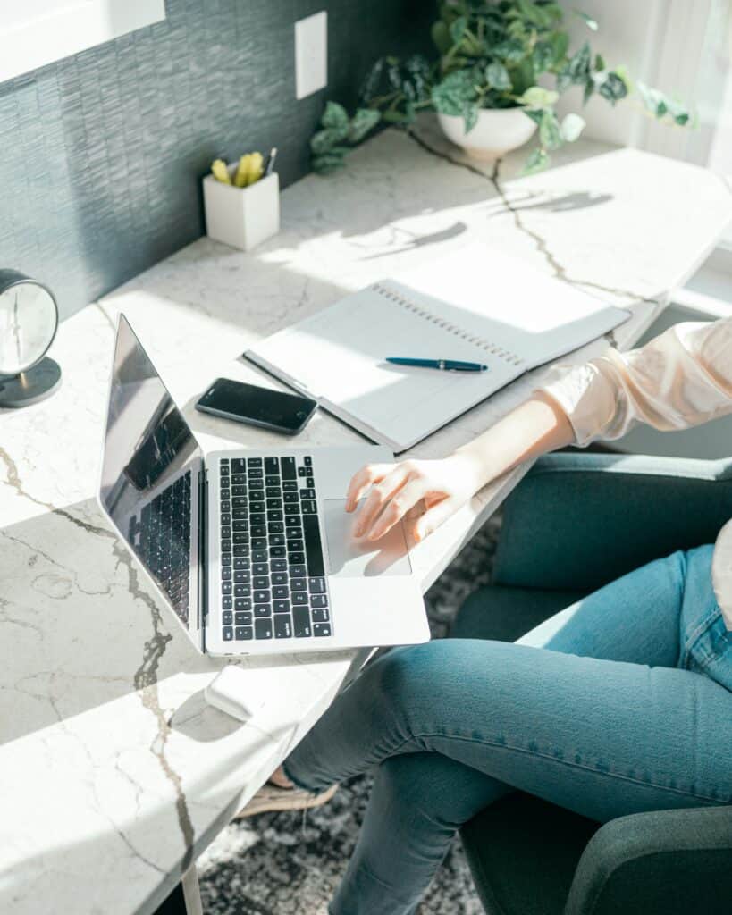 Person doing a quick body reset at desk to combat burnout and boost energy.