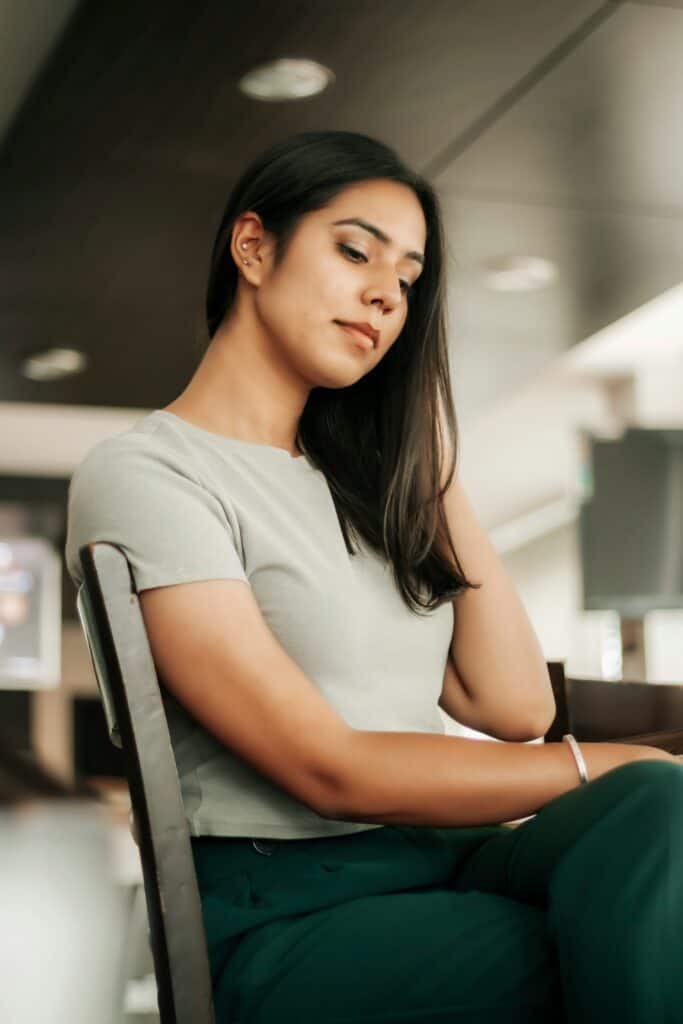 Woman sitting at desk, practicing a body-based reset for burnout relief.