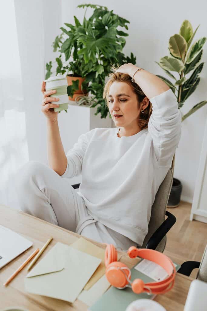 Woman performing a quick desk reset to reduce burnout and refresh during work.