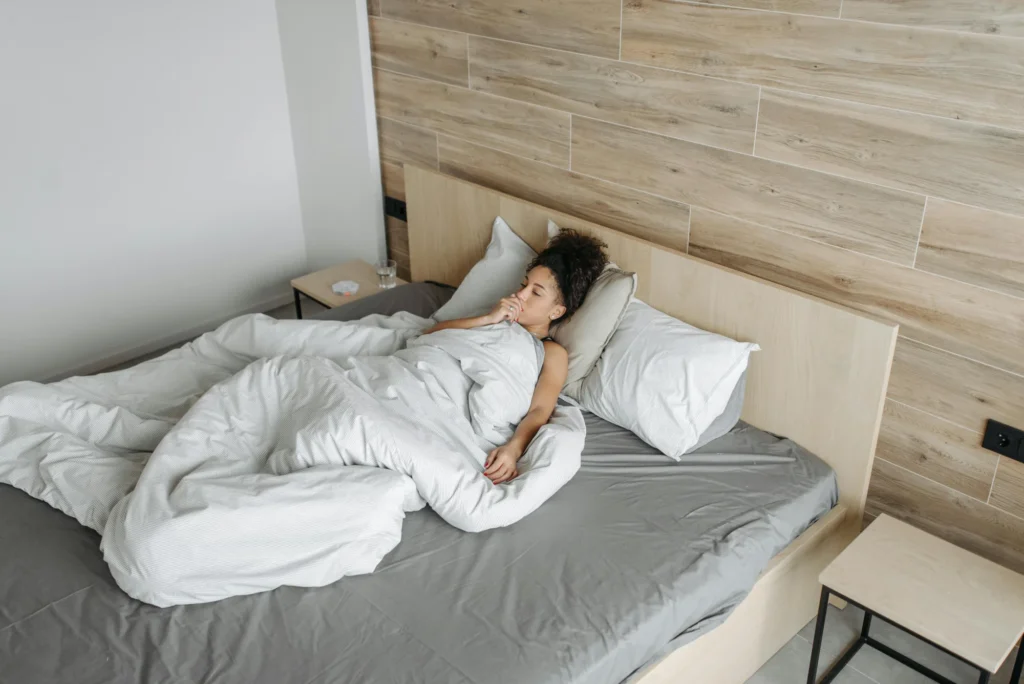 Woman exhaling slowly in bed
