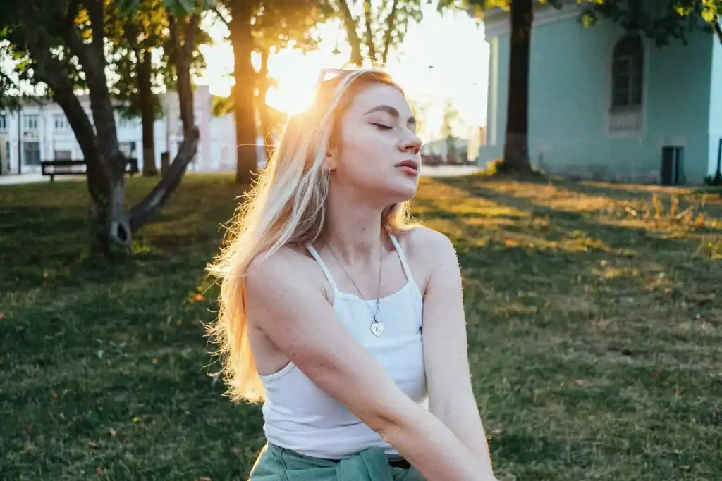 Woman eyes closed peaceful in sunny park