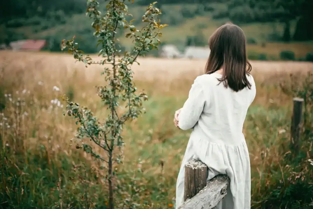 Woman linen dress back view meadow
