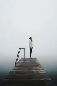 Woman Standing On Foggy Dock Eyes Up Woman standing on foggy dock eyes up